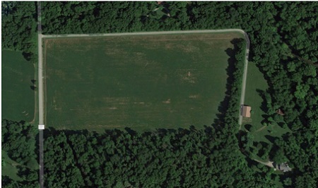 The aerial view of Dave Chappelle's empty green farm with his house seen very small from distance.