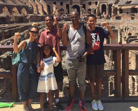 Dave Chappelle, Elaine and their three kids all raising their single hands as a fist.