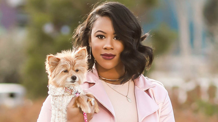 Jasmine Jordan holding a dog.