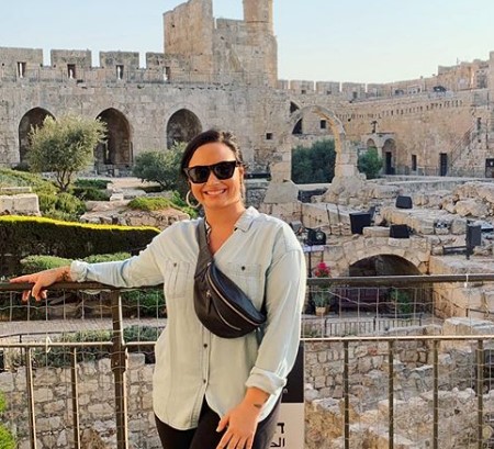 Demi posing in front of religious site.