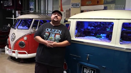 Gabe in front of one of his two Volkswagen buses turned into a fish tank.