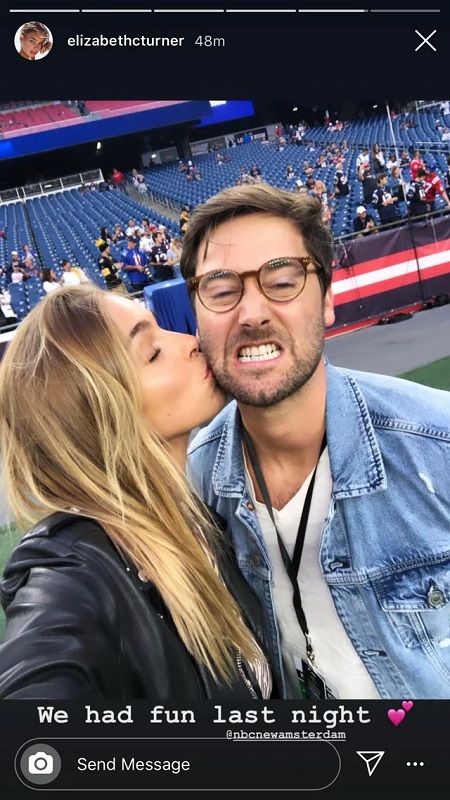 Liz clicking the selfie while kissing Ryan on the cheek as he is making a funny face by cringing his teeth and glasses on.