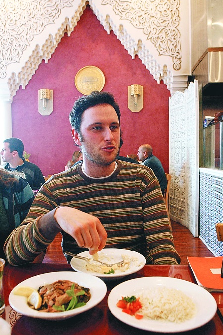 Noah Galuten eats Syrian food with friends at the Sham restaurant in Santa Monica, Calif., Dec. 12, 2008.