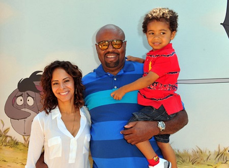 Chi Mcbride with his wife Julissa McBride and a son in his left hand.