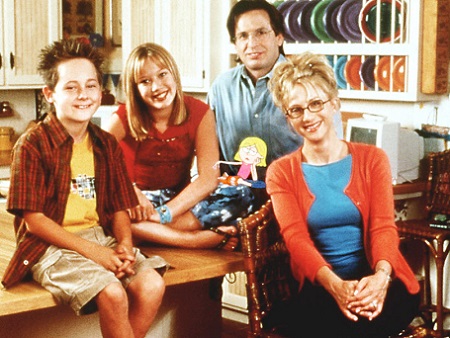 (From left) Jake, Hilary, Robert and Hailie all looking at the camera comfortably around a kitchen table.