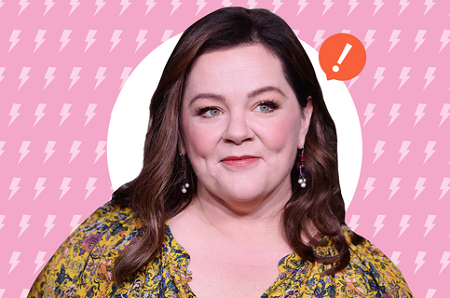 Melissa McCarthy smiling with an exclamation mark to her left.