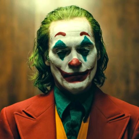 joaquin as joker in redsuite green hair and clown makeup 