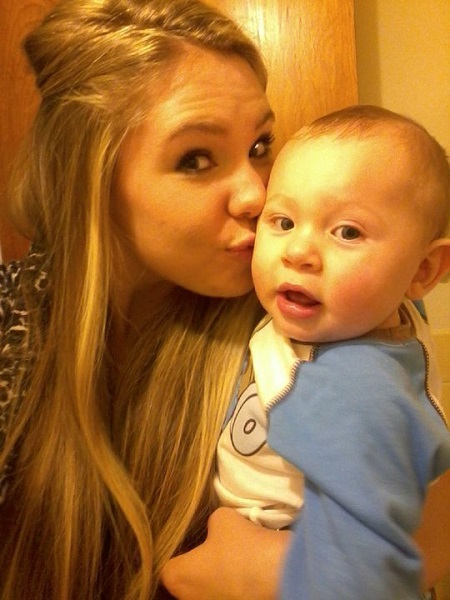 Kailyn Lowry Kissing her son Isaac as he looks at the camera in surprise.