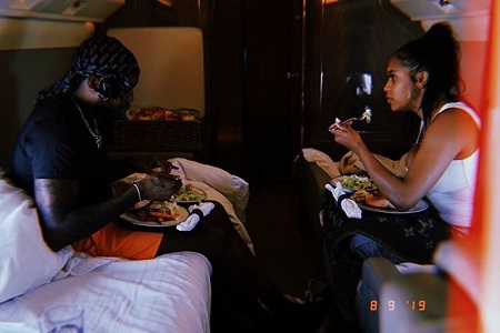 Meek Mill and Milan Harris eating breakfast while sitting on beds in a jet.