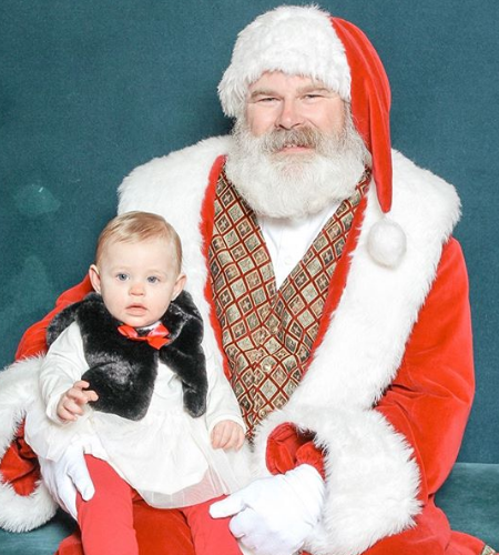 Mila seemed indifferent while she sits on Santa's lap.