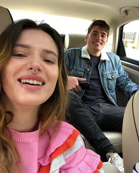 A photo of Bella Thorne (taking a selfie) and Gregg Sulkin from February 2019 inside a car.