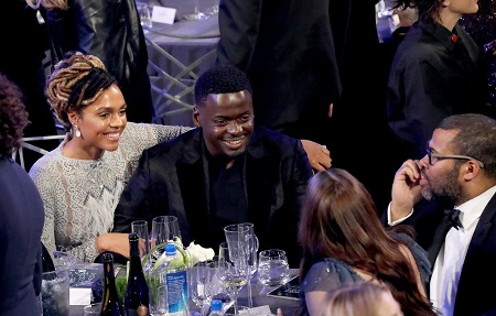 Amanda Crichlow with his arm around Daniel Kaluuya in a dinner table at the Golden Globe Awards.