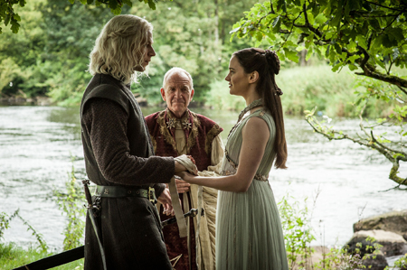 Rhaegar and Lyanna hold hands as a maester marries them in secret b the river.