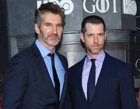 David Benioff and D.B. Weiss stand next to each other to take a photo.