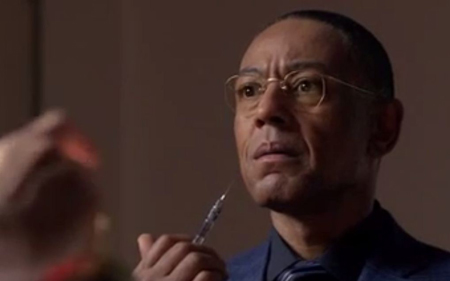 Gus Frings holds a syringe.