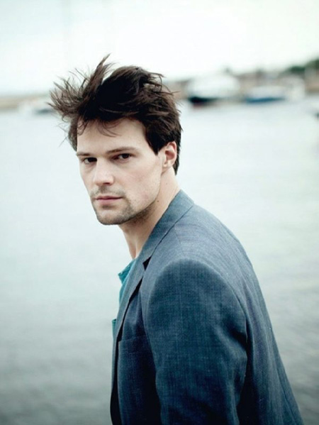 Danila posing for a photo by the river.