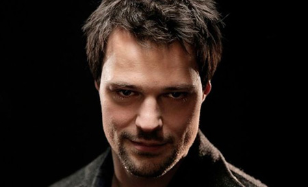 Danila with a smirk, looking into the camera