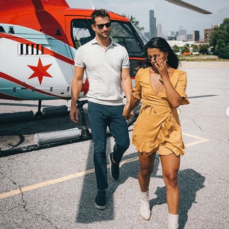 Katie and Chris near a chopper.