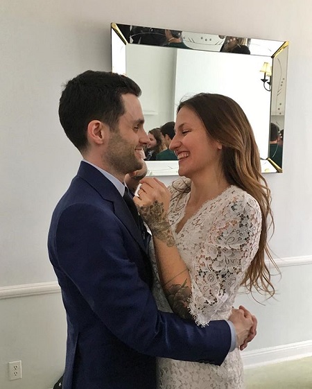 Penn Badgley holding his wife Domino Kirke at their wedding.\