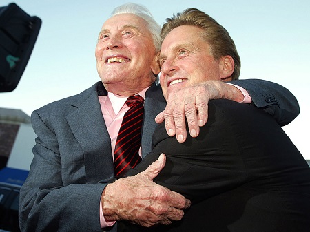 Kirk Douglas hugging Michael Douglas.