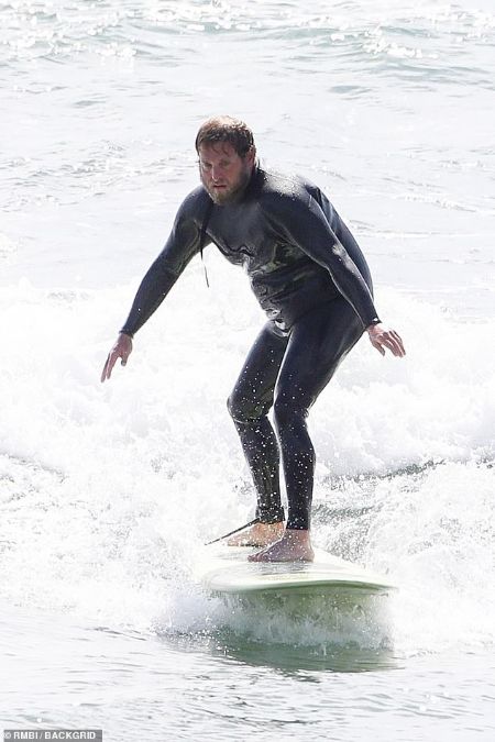 Jonah Hills surfing on the Malibu beach 