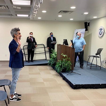 Tan France taking an oath at the US Citizenship and Immigration Services building.