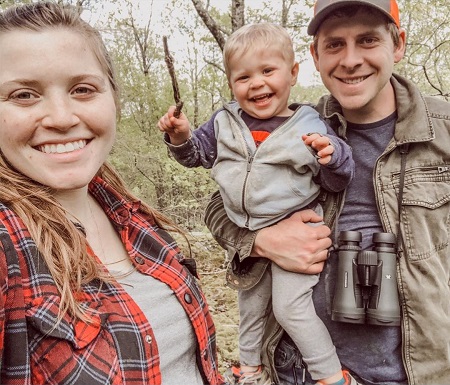 Joy-Anna Forsyth taking a selfie with his husband Austin Forsyth carrying their son Gideon.